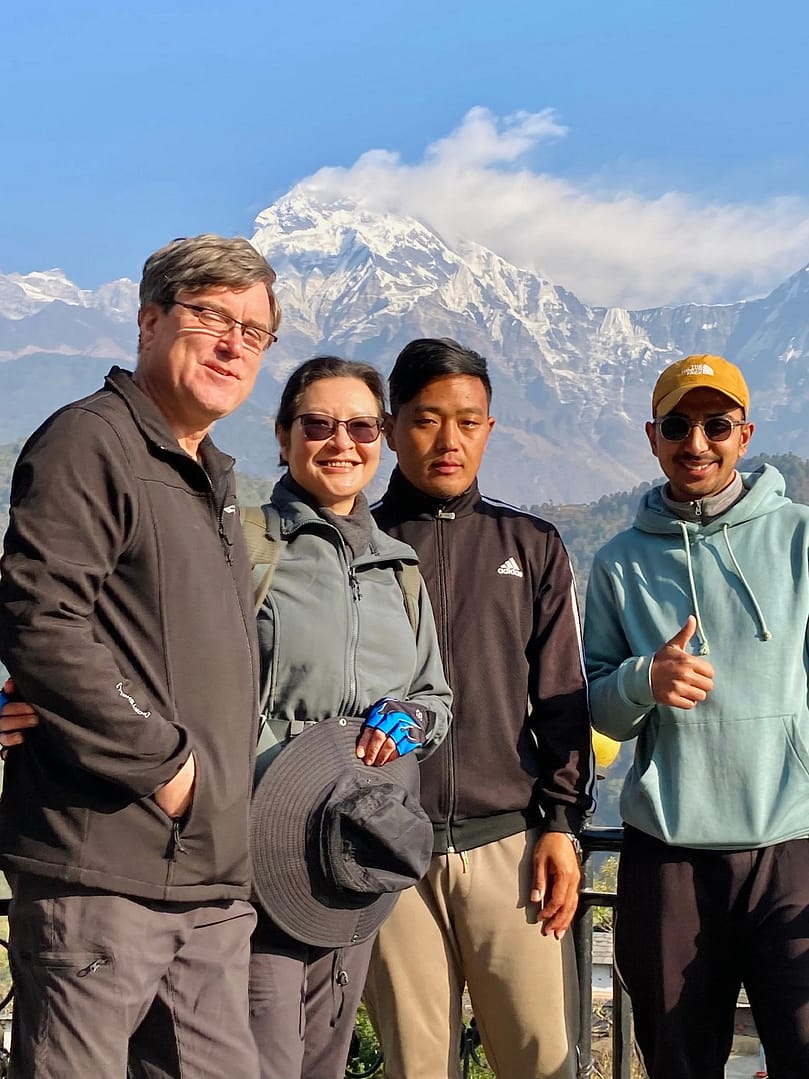 Female tour guide sharing cultural insights with travelers in the heart of Nepal, enhancing their trekking experience